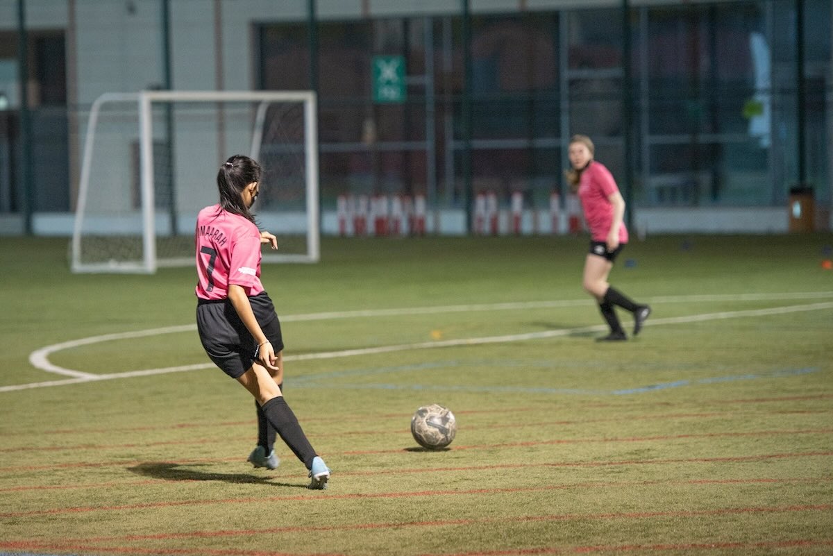 Girls playing on astroturf