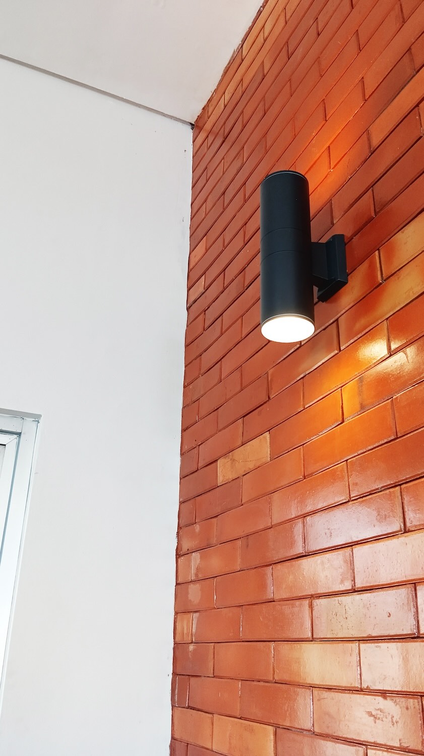 Exposed red brick exterior lighting display