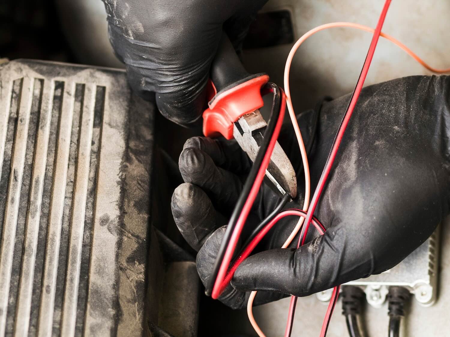 Electrician using cutters to cut wire